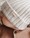 strickgut-baby-muetze-gerippt-aus-merinowolle-stein